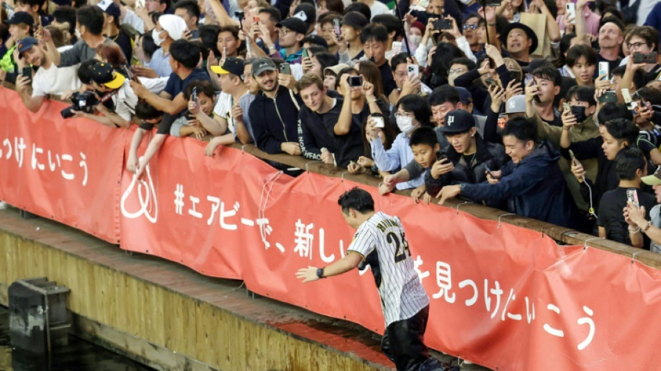 Japan baseball fans leap into river as 'Curse of the Colonel' lifted